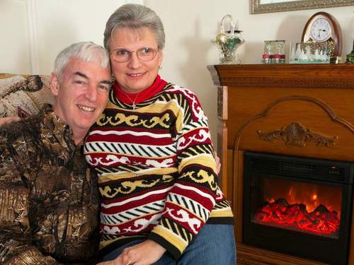 Man and woman in front of fire place
